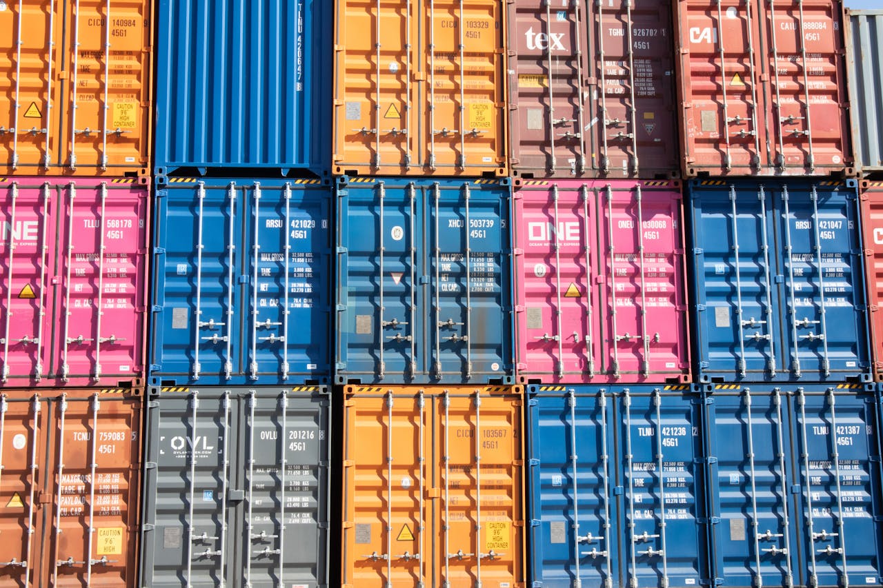 about-02 Stacked multicolored shipping containers at a Hamburg port, showcasing industrial logistics.